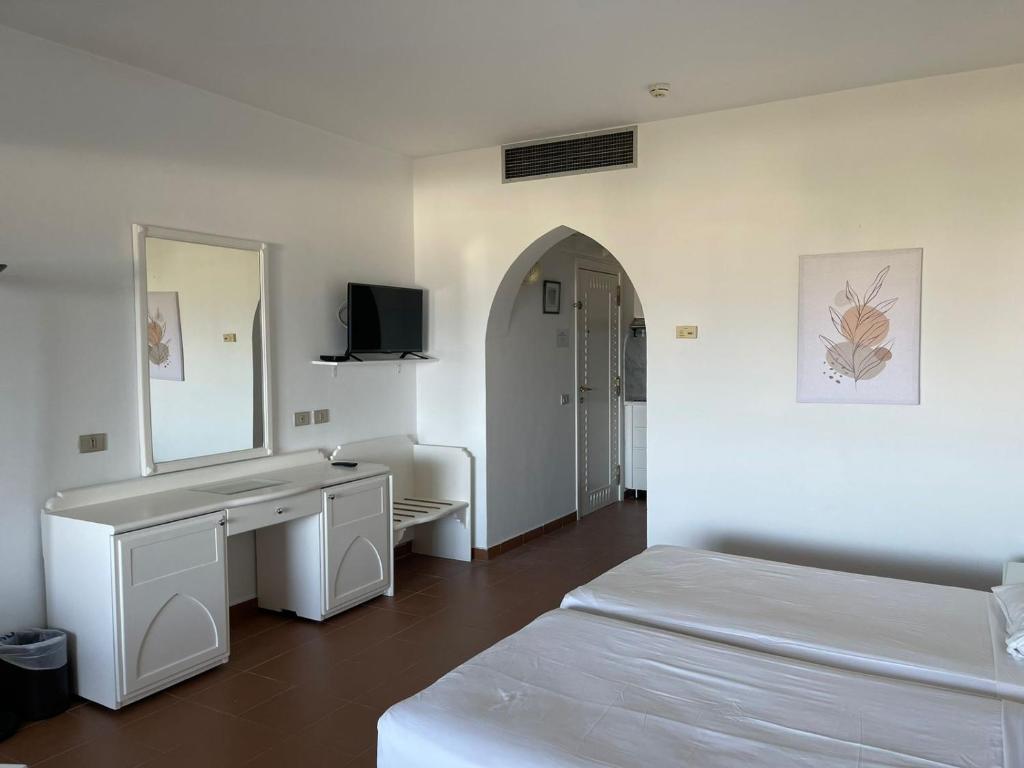 Postel nebo postele na pokoji v ubytování Domina Coral Bay Private Studios
