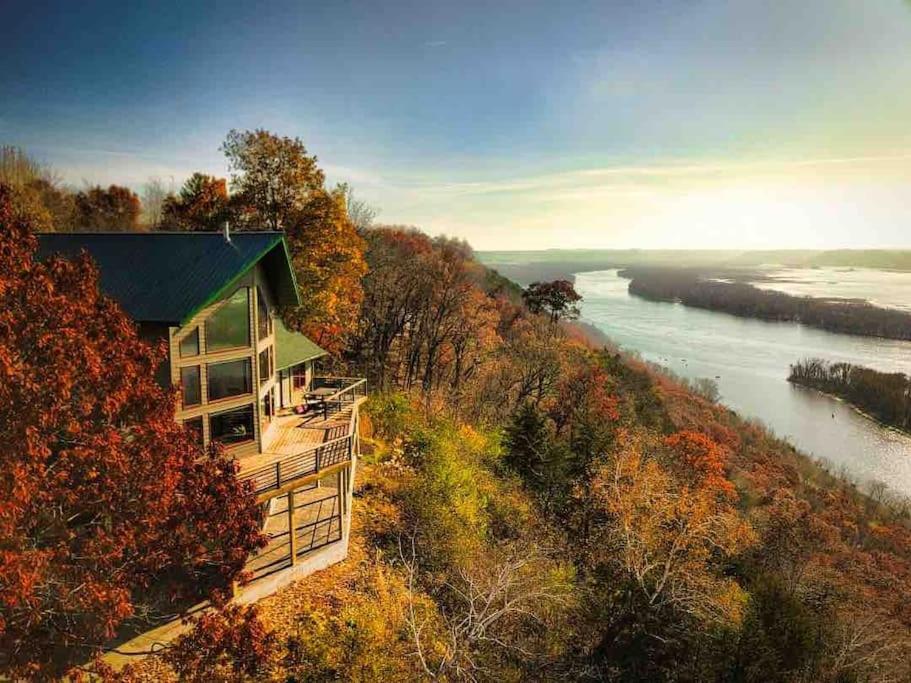 a house on a hill next to a river at Eagles Landing- Scenic 4 bedroom 5 bath sleeps 15 in De Soto