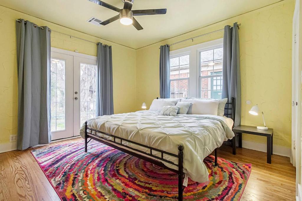 a bedroom with a bed and a ceiling fan at Pastel Palace - near Plaza & Uptown 23rd in Oklahoma City