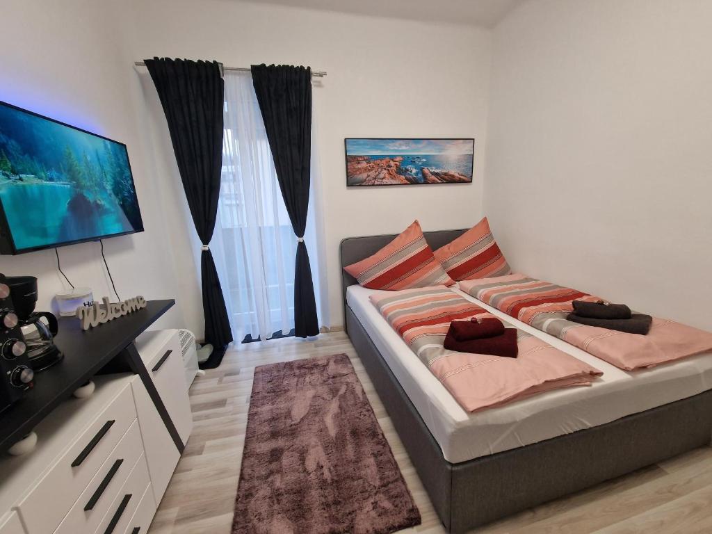 um quarto com uma cama e uma televisão de ecrã plano em Appartement 223 em Bad Aussee