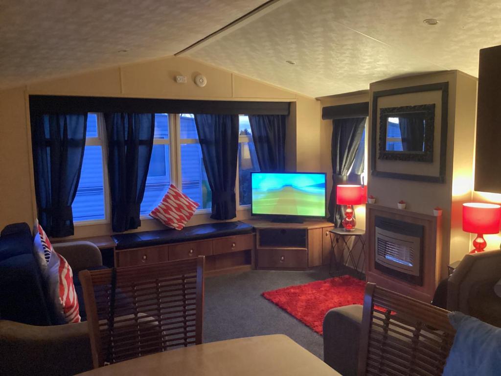 a living room with a flat screen tv and a couch at Holiday Home At Seton Sands in Port Seton
