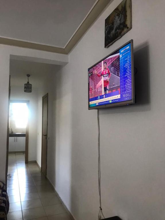 a flat screen tv on a wall in a room at Ceuta fnideq in Fnidek