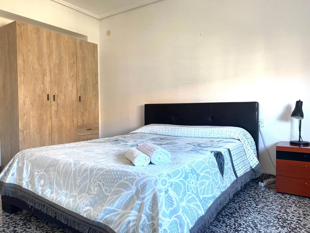 a bedroom with a bed with two towels on it at private room in shared apartment Valencia WorkStay in Valencia