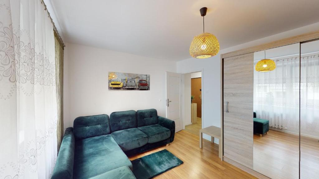 a living room with a blue couch in a room at Kotlarska 7 TectumApartments in Wrocław