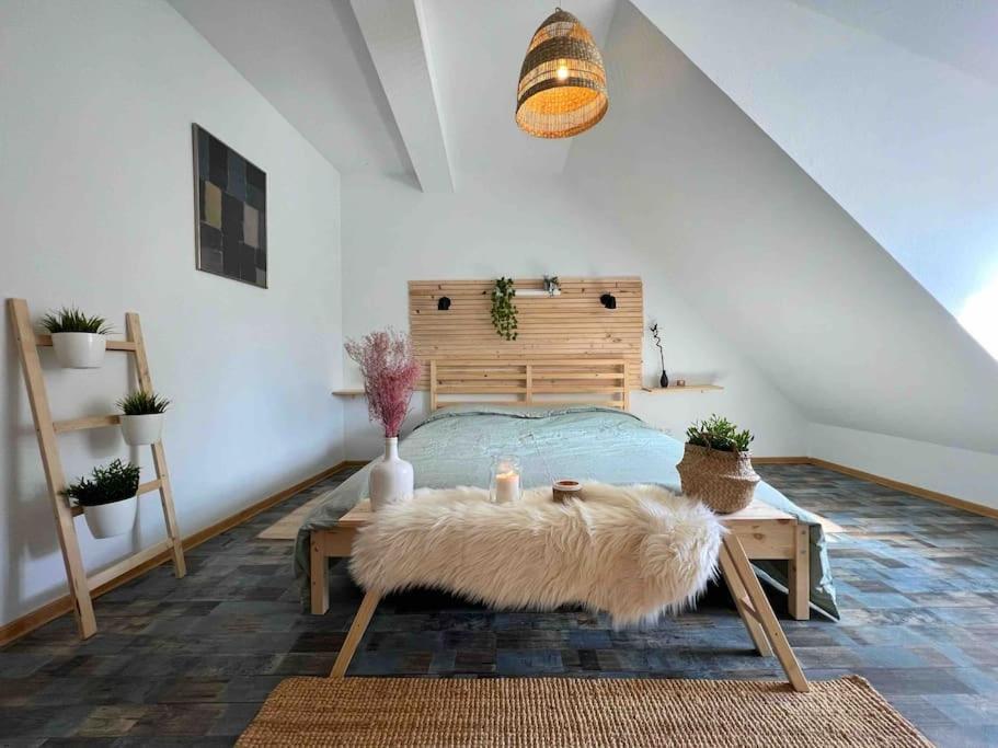 a bedroom with a bed and a table with a rug at Boho Apartment in der Stadtmitte in Lahr