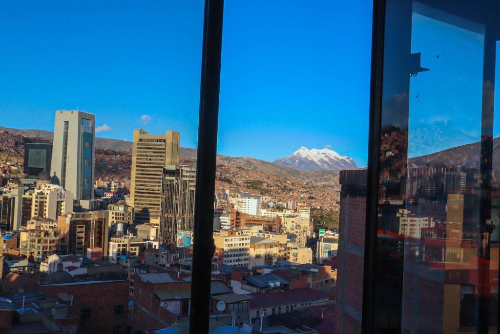 a view of a city from a window at Lobo Hostel La Paz in La Paz