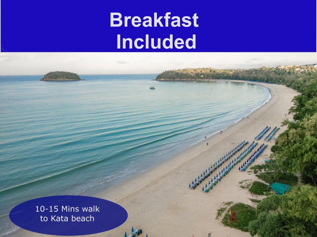a beach with umbrellas and the text breakfast included at Kata Forte Resort in Kata Beach