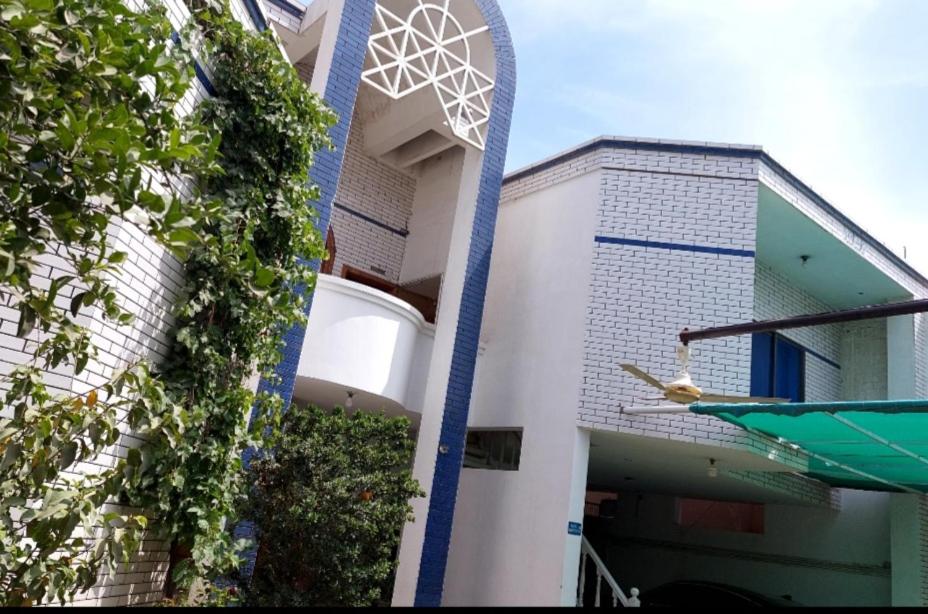 a building with a clock on the side of it at Motel Paradise inn in Bahawalpur