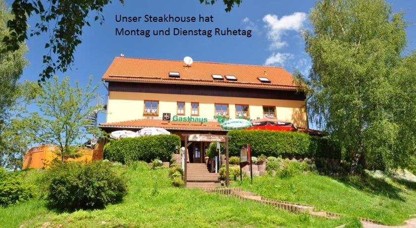 a house on a hill with the words user residence hit moving and disaster building at Steakhouse & Pension Crazy Horse in Suhl