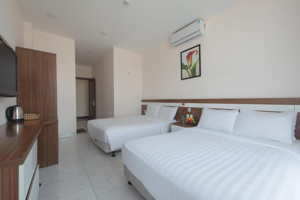 Postel nebo postele na pokoji v ubytování Khách sạn CLIFFHOUSE NHA TRANG