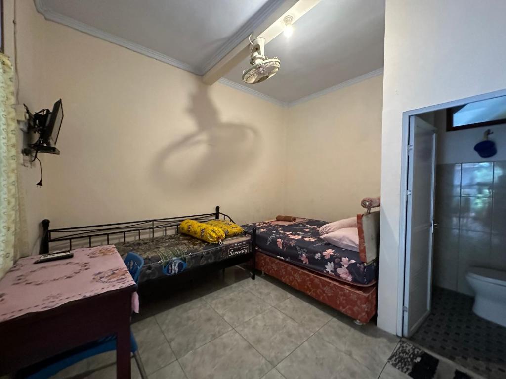 Postel nebo postele na pokoji v ubytování Nadyah Syariah Homestay
