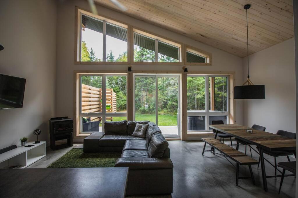 a living room with a couch and a table at Le Boréal in Saint-Donat-de-Montcalm