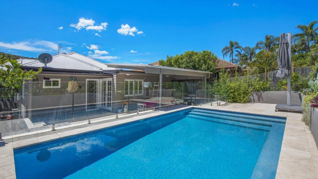 a swimming pool in the backyard of a house at Bayview Escape Woy Woy Bay in Woy Woy