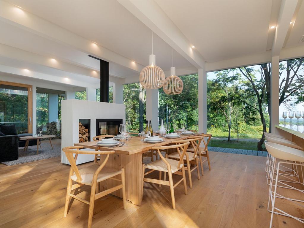 a dining room with a table and chairs and a fireplace at Yukihyo by H2 Life in Niseko