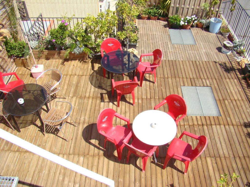 a patio area with chairs, tables, chairs and umbrellas at Hostal Platja in Cambrils