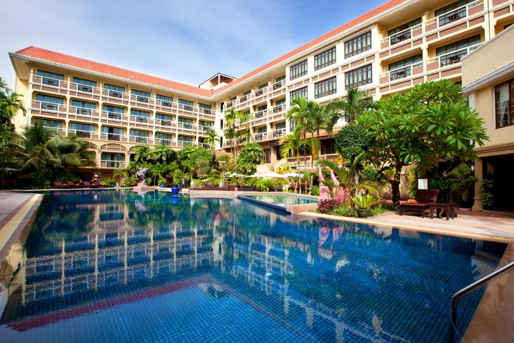 a hotel swimming pool in front of a building at Prince Angkor Hotel & Spa in Siem Reap