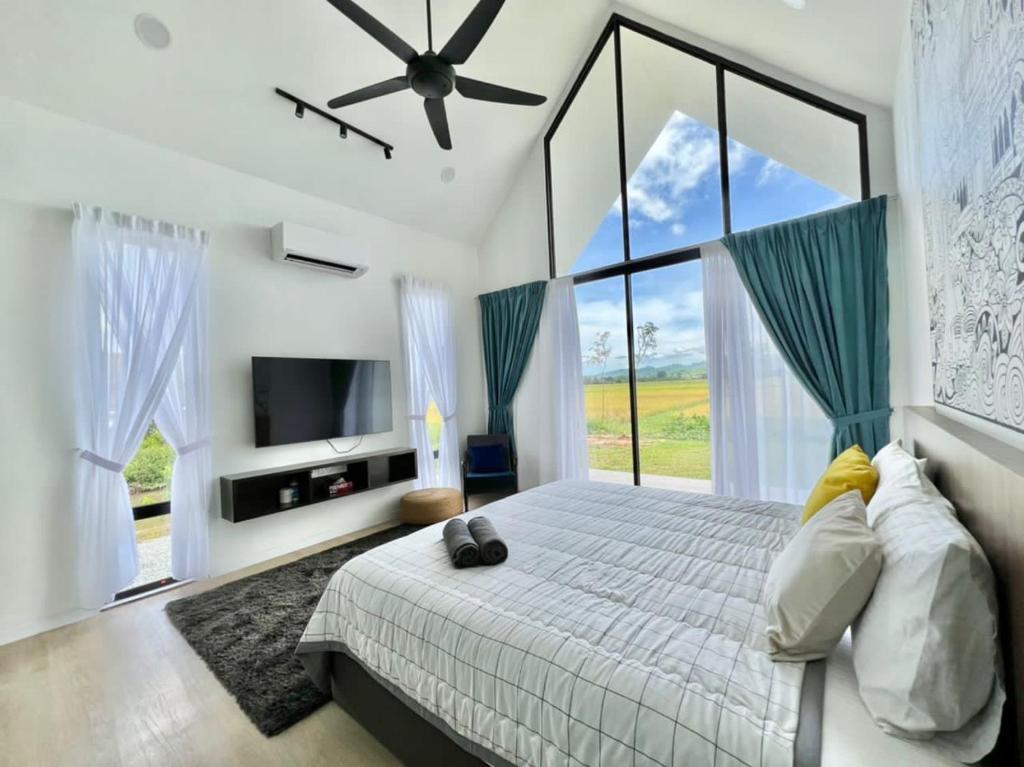 a bedroom with a large bed and a large window at Ezu Isle Langkawi Pool Villa in Pantai Cenang