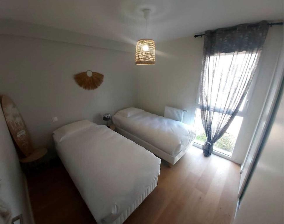 Łóżko lub łóżka w pokoju w obiekcie Ville les flots bleus Proche golf Arcachon