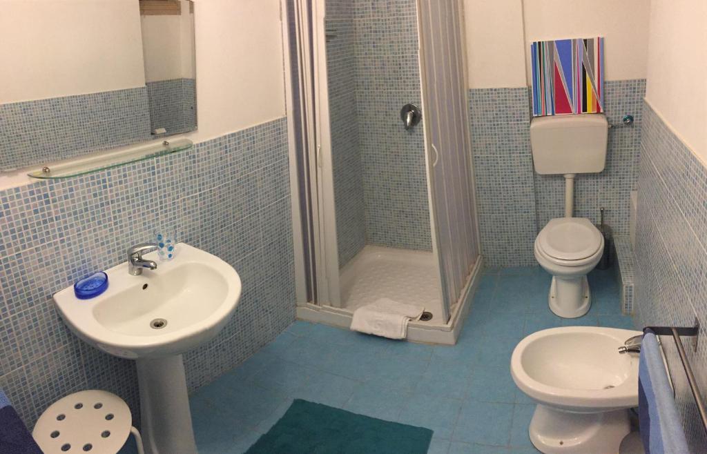 a bathroom with a sink and a toilet and a shower at B&B La Galleria in Palermo