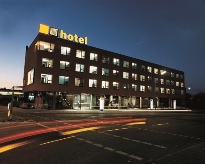 a hotel with a sign on top of a building at Kult Hotel in Ingolstadt