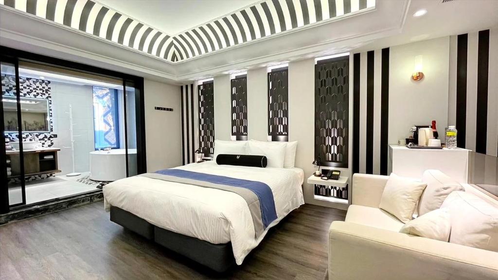 Postel nebo postele na pokoji v ubytování H Motel璽悅國際精品旅館