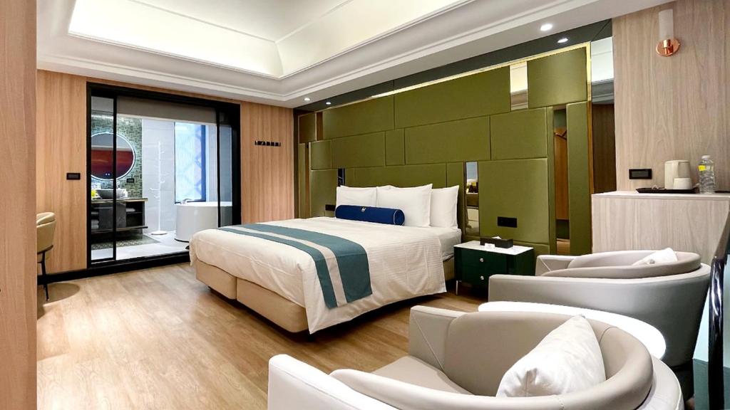 Postel nebo postele na pokoji v ubytování H Motel璽悅國際精品旅館
