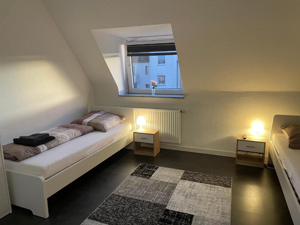 Kleines Zimmer mit einem Bett und einem Fenster in der Unterkunft Ferienwohnung Nähe Hbf Bremerhaven in Bremerhaven