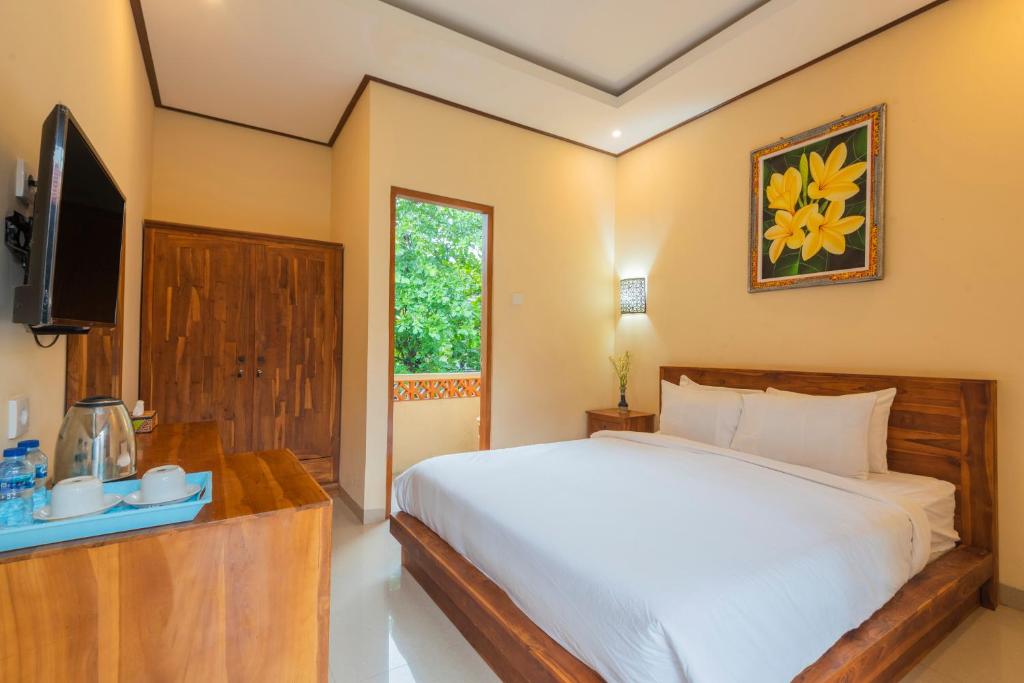 Postel nebo postele na pokoji v ubytování Liliy Guest House Legian near Beach