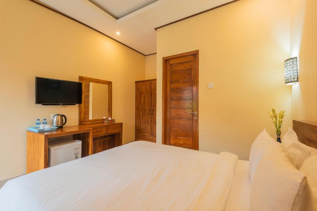 Postel nebo postele na pokoji v ubytování Liliy Guest House Legian near Beach
