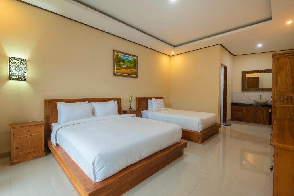 Postel nebo postele na pokoji v ubytování Liliy Guest House Legian near Beach