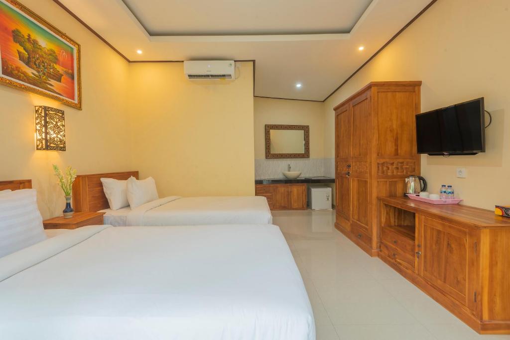 Postel nebo postele na pokoji v ubytování Liliy Guest House Legian near Beach