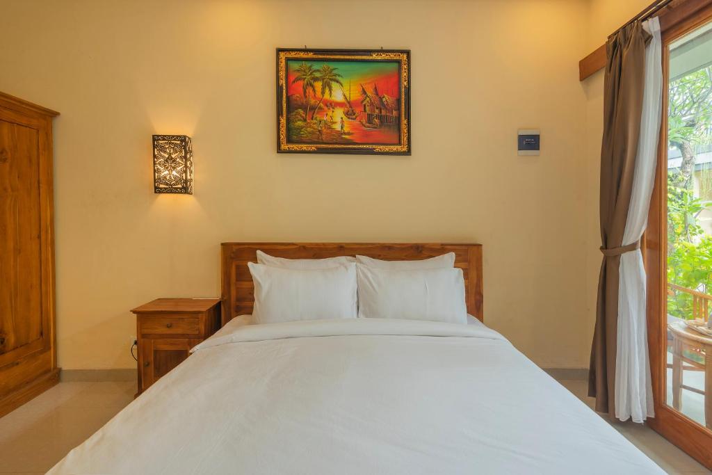 Postel nebo postele na pokoji v ubytování Liliy Guest House Legian near Beach