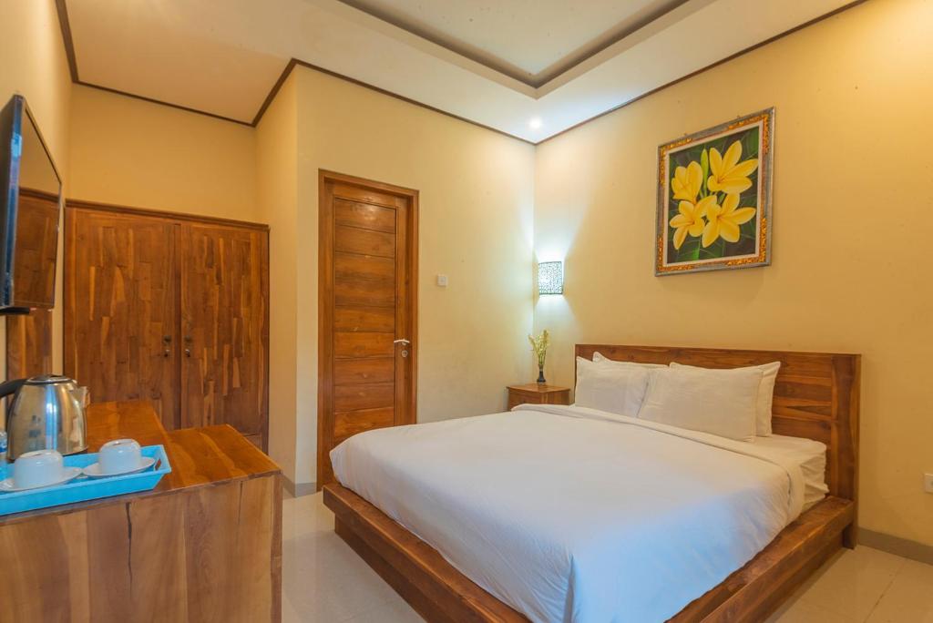 Postel nebo postele na pokoji v ubytování Liliy Guest House Legian near Beach