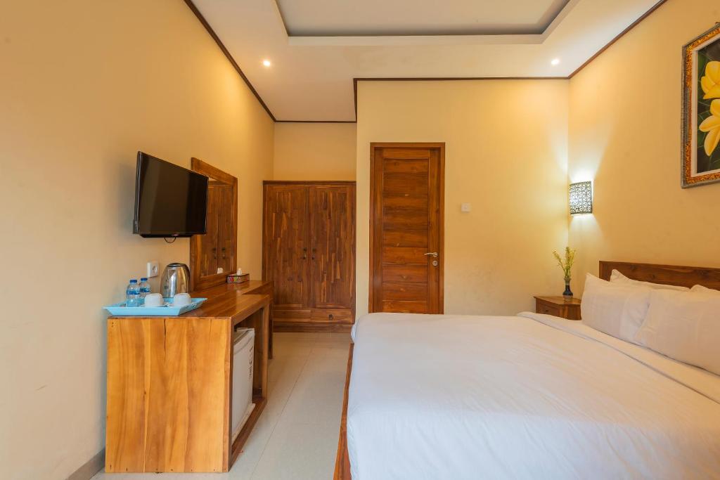 Postel nebo postele na pokoji v ubytování Liliy Guest House Legian near Beach