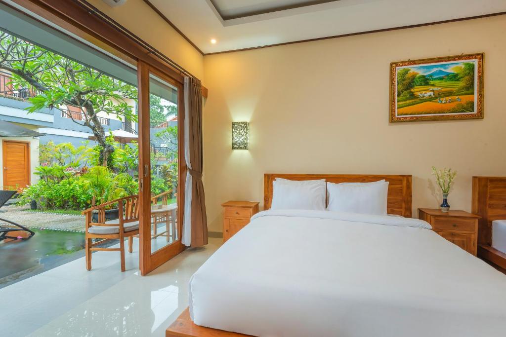 Postel nebo postele na pokoji v ubytování Liliy Guest House Legian near Beach