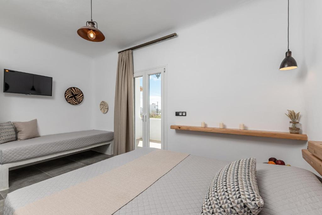 A bed or beds in a room at Sunshine Plaka Naxos