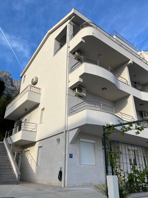 a building with balconies on the side of it at Apartments Ćorić in Baška Voda