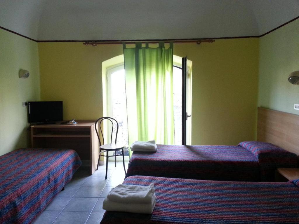 Postel nebo postele na pokoji v ubytování Hotel Stazione