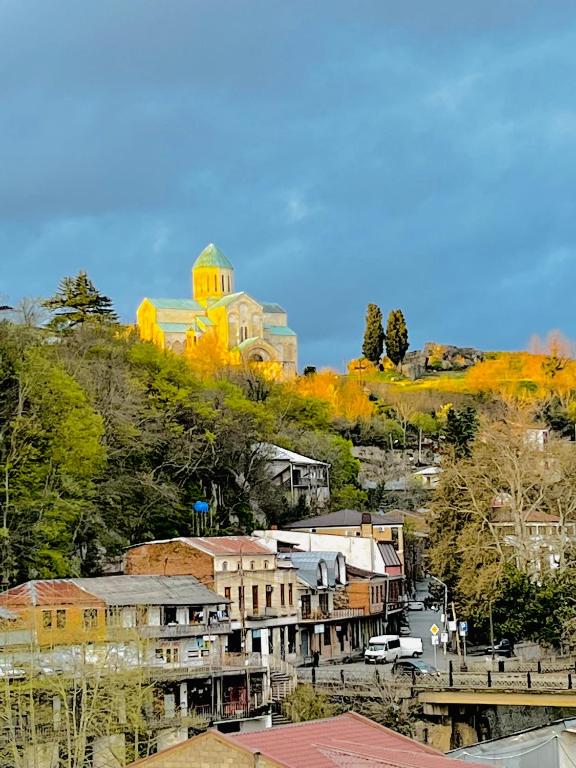 a town with a church on top of a hill at Georgian Palace Hotel in Kutaisi