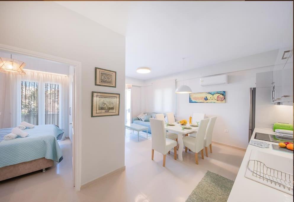 a white room with a bedroom and a dining room at Frises Corfu Town Apartment in Ágios Rókkos