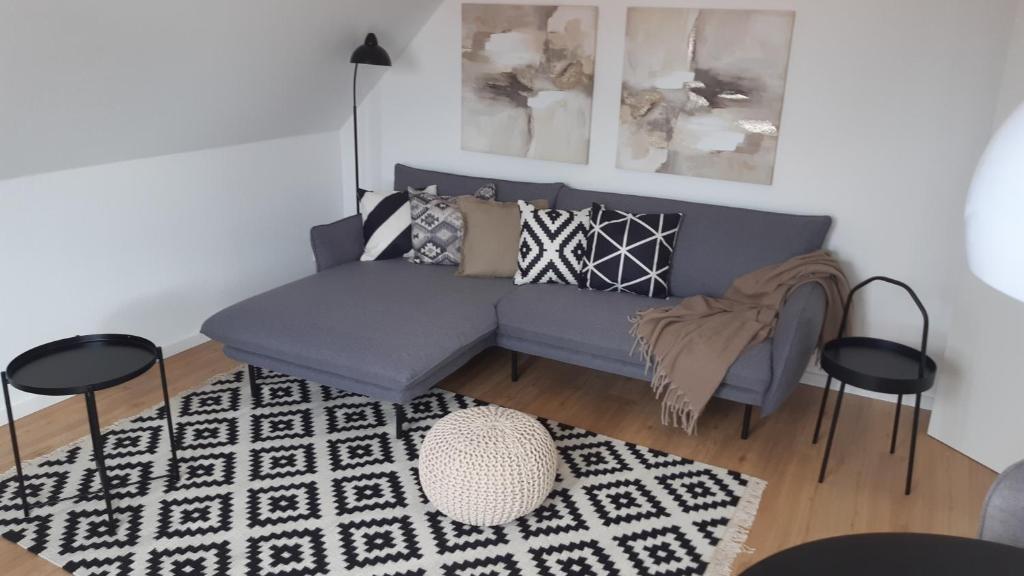a living room with a blue couch and a rug at Haus Polarstern Ferienwohnung Kapella in Borkum