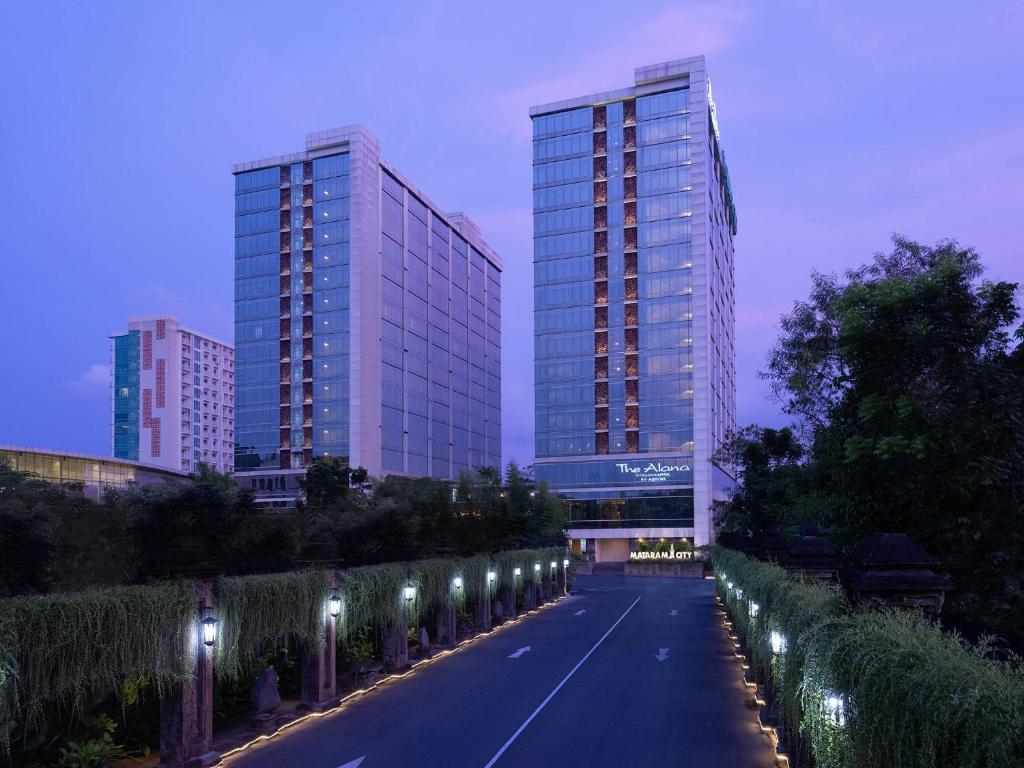 a street with two tall buildings and a row of lights at The Alana Yogyakarta Hotel and Convention Center in Yogyakarta