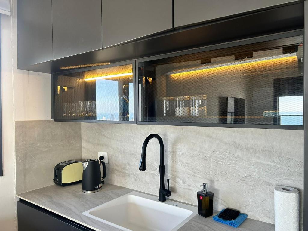 a kitchen with a sink and a counter top at panoramic apartment EdenTower in Bat Yam