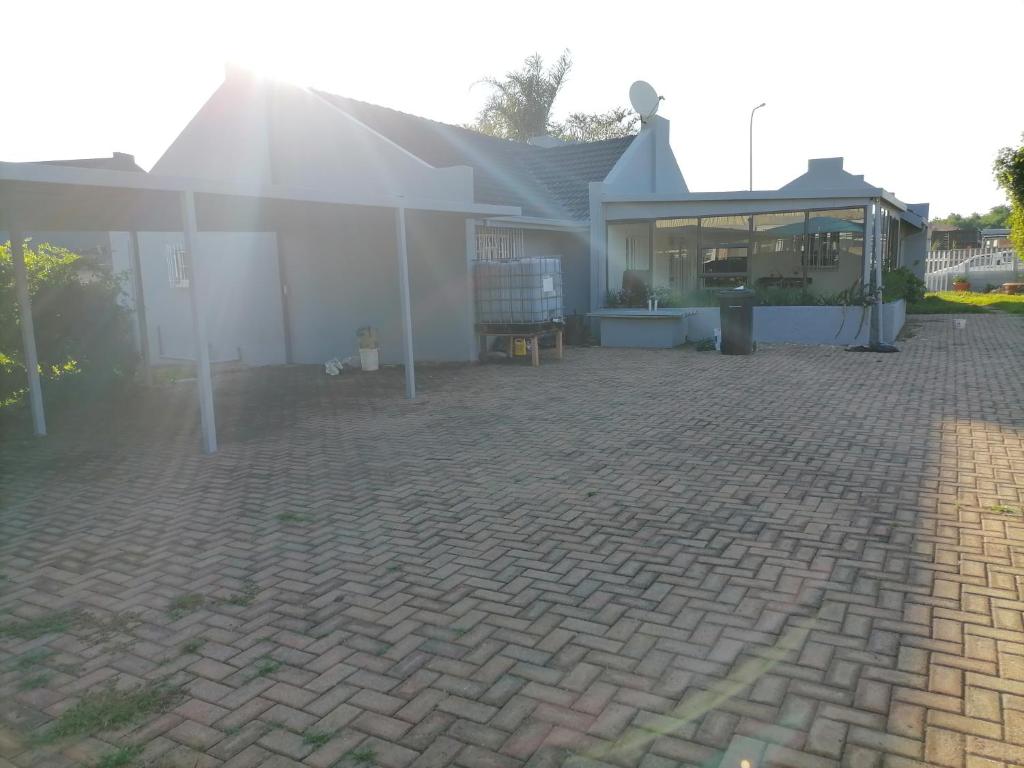 a house with a brick patio in front of it at 8 on twentieth in Brakpan