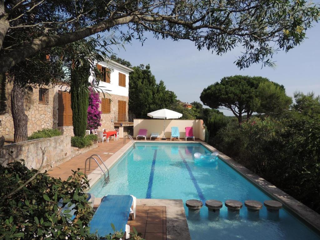 a swimming pool in front of a house at Dalí in Begur