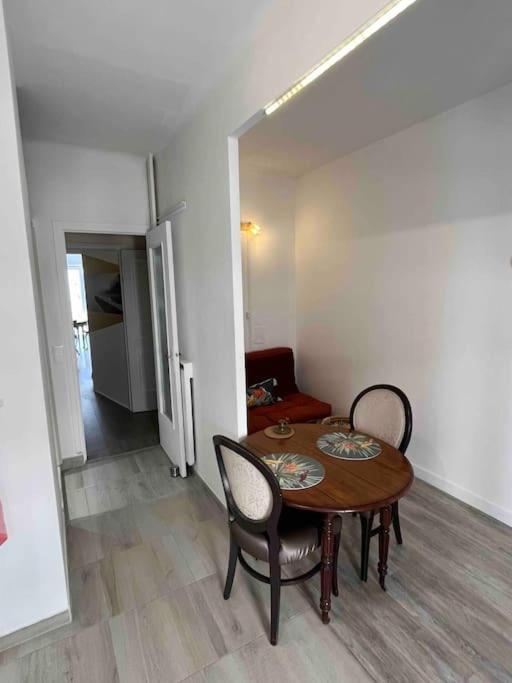 a dining room with a table and two chairs at Appartement atypique et original in Nice