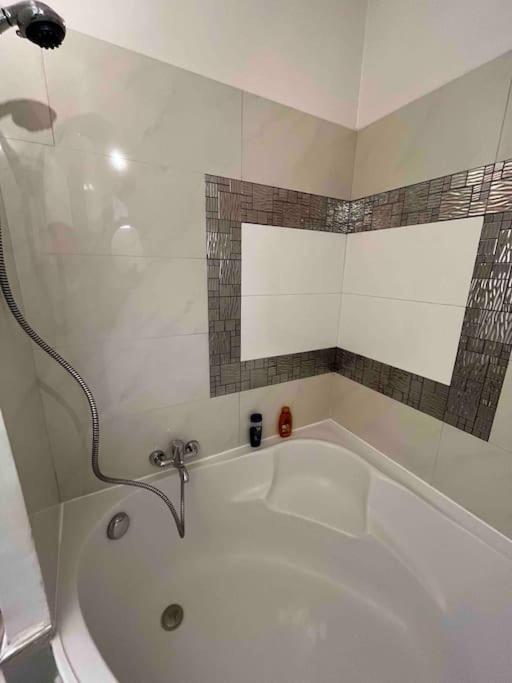 a white bath tub with a faucet in a bathroom at Appartement atypique et original in Nice
