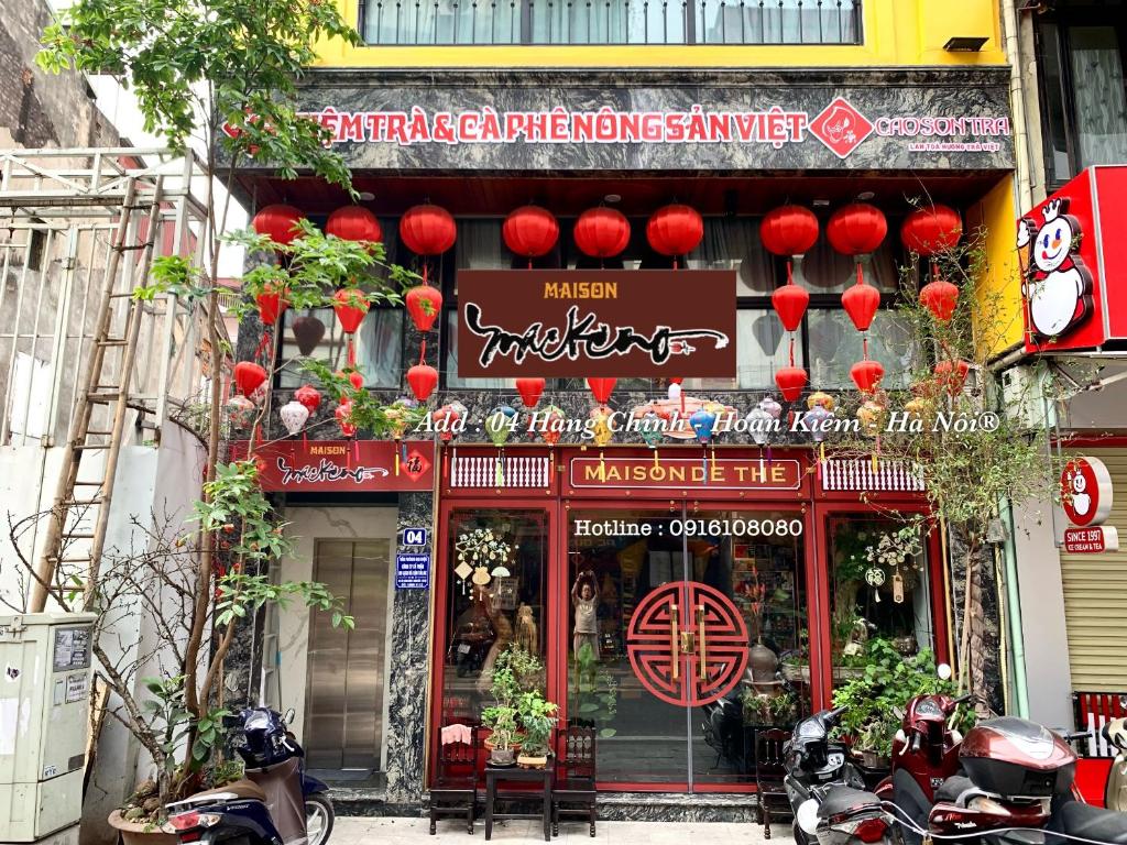 a chinese restaurant with red lanterns in front of it at Maison Mackeno in Hanoi