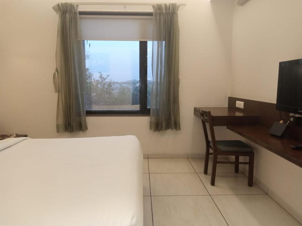 Postel nebo postele na pokoji v ubytování Hotel Kanan