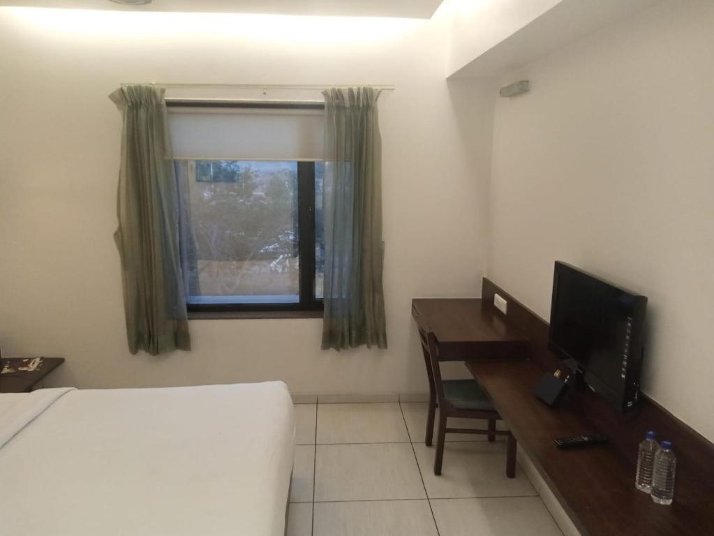 Postel nebo postele na pokoji v ubytování Hotel Kanan